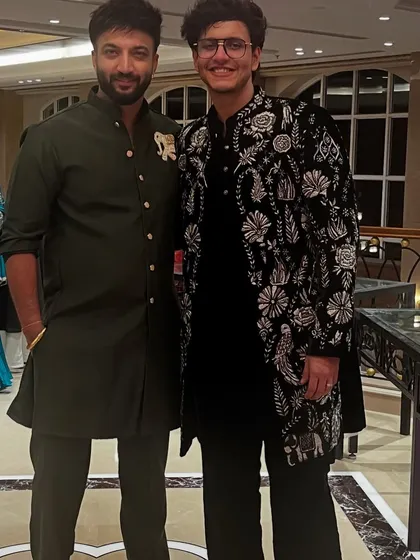 One of our designers with client Nischay Malhan, who is wearing his custom black velvet Indo-Western jacket. We love collaborating with clients to create their perfect look.