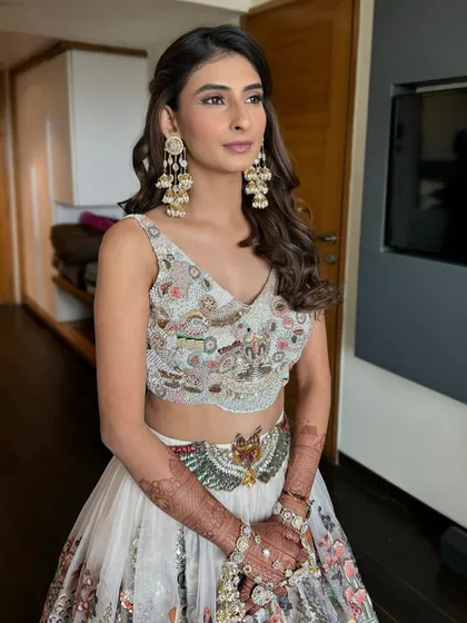 A close-up of Yashvi's carnival glam. The makeup is kept soft and pretty to balance the colorful outfit and statement jewelry.