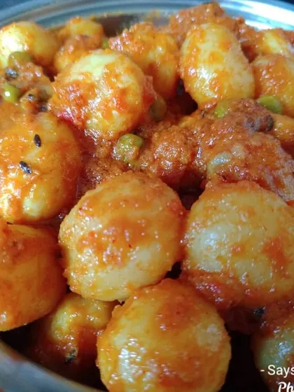 Niramish Aloor Dom is a timeless classic, especially when paired with 'phulko luchi' (puffy breads). I make it with baby potatoes in a dry, spicy tomato-based gravy with fresh peas for color.