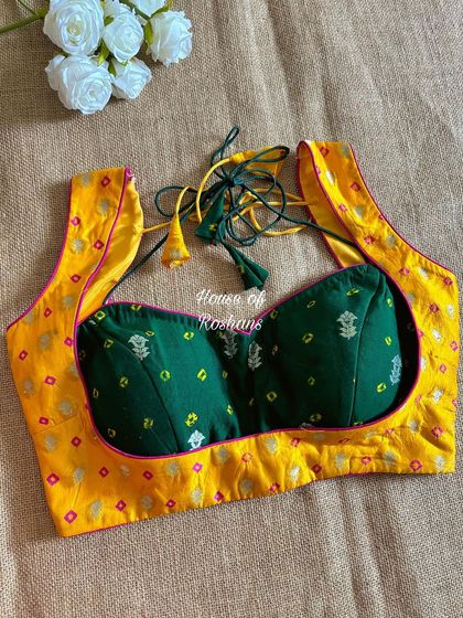 A vibrant and festive blouse combining a yellow bandhej print with a green embroidered bust. The color blocking is perfect for a fun, festive look.