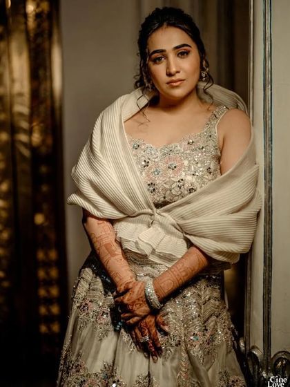 An elegant and structured look for a bridal client. The pleated wrap detail adds a unique, high-fashion element to this beautiful embellished gown.