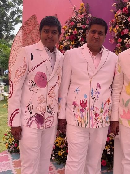 Father and son wearing custom-painted floral jackets. It was a joy to create these coordinating pieces, each with a unique design that still felt connected, for them to wear at a special family event.