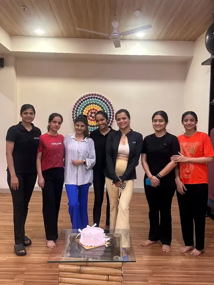 A group photo with one of our beloved members and her celebration cake. This is what our community is all about.