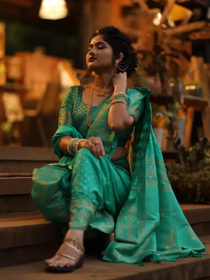 The grace of a Nauvari saree. This traditional Marathi look is all about poise and elegance, with a classic updo, subtle makeup, and the unique drape of the nine-yard saree.