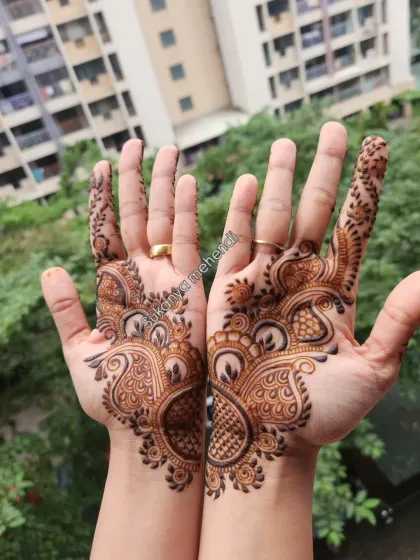The beauty of Arabic mehendi lies in its graceful flow. This design features bold, beautiful peacock-inspired patterns that adorn the hands without being too dense, perfect for any celebration.