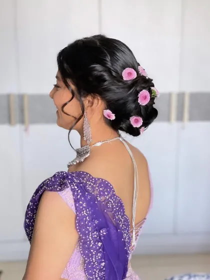 A soft and romantic floral bun. I used these delicate pink flowers and tucked them into a textured updo for a look that is pretty and feminine.