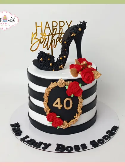 Celebrate a milestone with glamour and style. This "Boss Lady" cake for a 40th birthday features bold black and white stripes, a handcrafted edible stiletto, and elegant red roses, perfect for a chic and fabulous celebration.