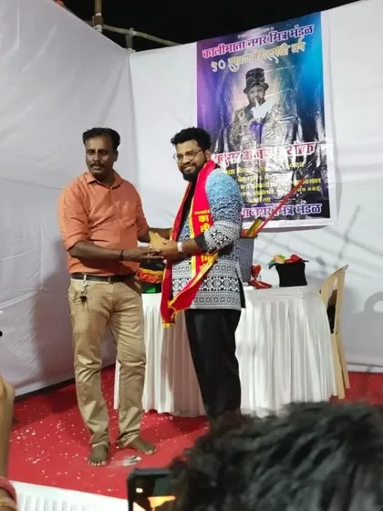 Being felicitated on stage after a successful show for the Kalimata Nagar community. It's an honor to entertain at local festivals and be a part of the celebration.