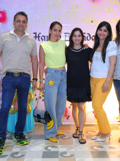 A group of friends and family enjoying the party atmosphere at a butterfly-themed celebration.