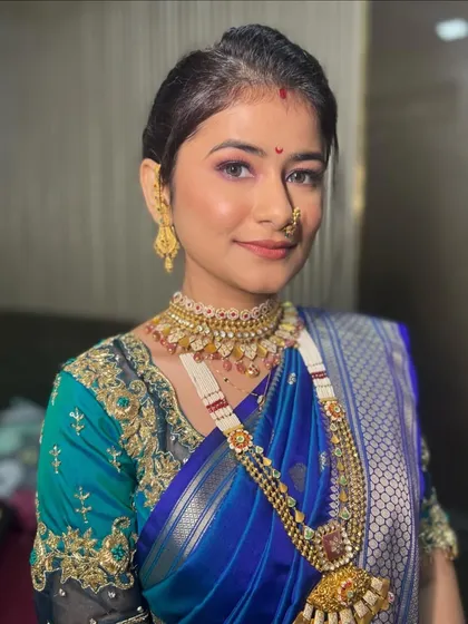 A portrait of a serene Maharashtrian bride. The makeup enhances her natural beauty, making her look like a vision of grace.