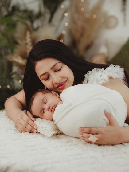 There's nothing more peaceful than a sleeping baby resting on their mother's chest. This photo captures the serene and loving bond between mother and child.