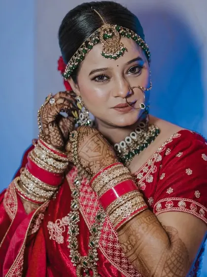 Bridal aesthetics at their finest. My beautiful bride looks absolutely regal, with her intricate mehendi peeking through as she adjusts her jewelry.