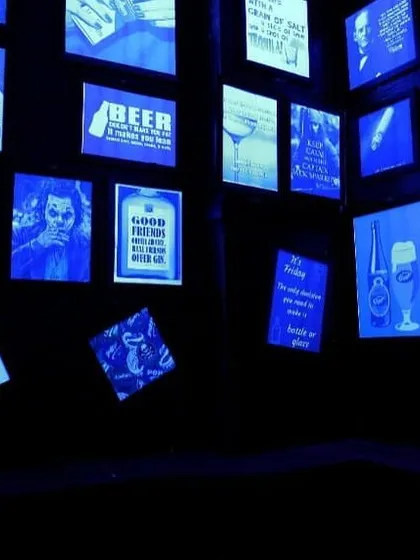 A creative feature wall at Harmony Inn, where our lighting system uses blue light to make the artwork pop. This shows how automation can be used for dynamic decorative effects in commercial interiors.