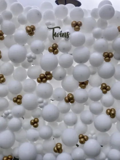Celebrating the arrival of twins calls for something special. Here, I designed a full balloon wall using classic white with small gold clusters for an elegant and clean look, creating a beautiful backdrop for a baby shower or naming ceremony.