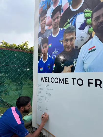 An Odisha FC player signing our welcome board during their practice session at our home ground.