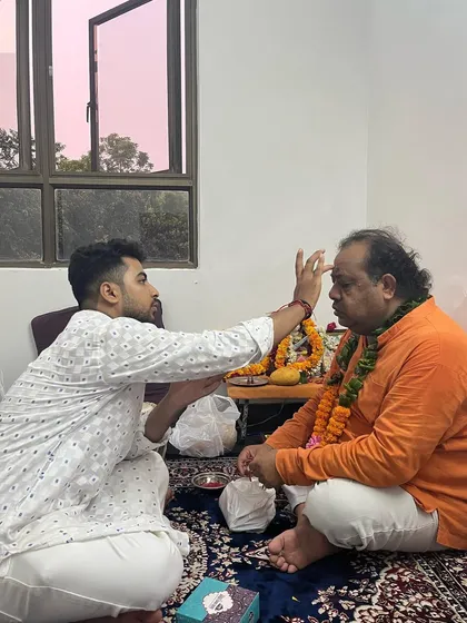 Applying a tilak to my Guru's forehead as a mark of respect and gratitude.