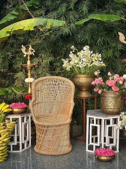 I honor timeless traditions by creating authentic South Indian decor, featuring elements like banana plants, brass lamps, and fresh flowers for a classic photo booth.