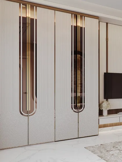 A detailed view of the wardrobe, showcasing the intricate grooved patterns and how they interact with the inset bronze mirrors. This highlights the level of custom craftsmanship.