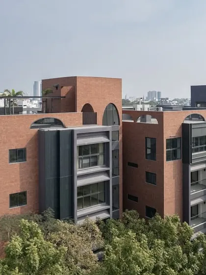 The ARCUS residential building in Chennai demonstrates our ability to create impactful architecture in a dense urban setting. The design uses a combination of brick and contemporary forms, rising above the lush tree canopy while respecting the neighborhood's scale.