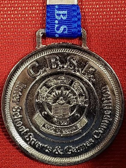 A close-up of a CBSE Inter-School Sports & Games Competition medal.