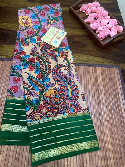 An intricate Tree of Life Kalamkari print on a Mysore silk saree with a green border.