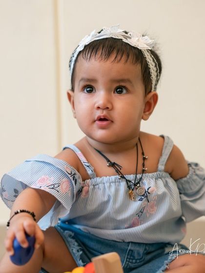 A sweet, innocent portrait of a baby girl, her wide eyes full of curiosity.