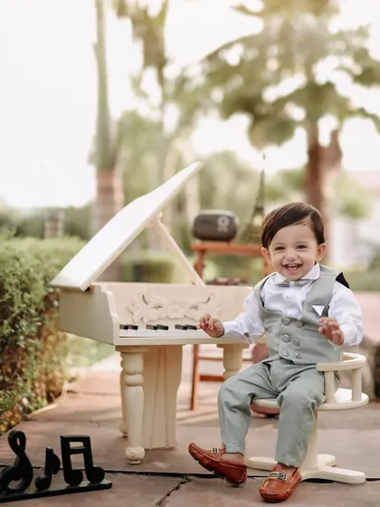 A dapper little gentleman at his piano. His big, happy smile and smart outfit make this one of my favorite shots from this outdoor musical session.