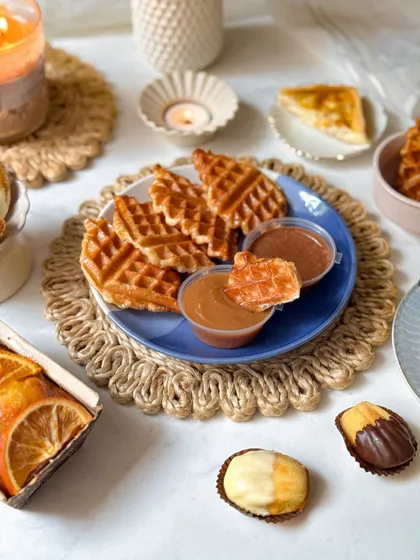 A close-up of the mini croffles from the brunch box, served with caramel and chocolate dips.