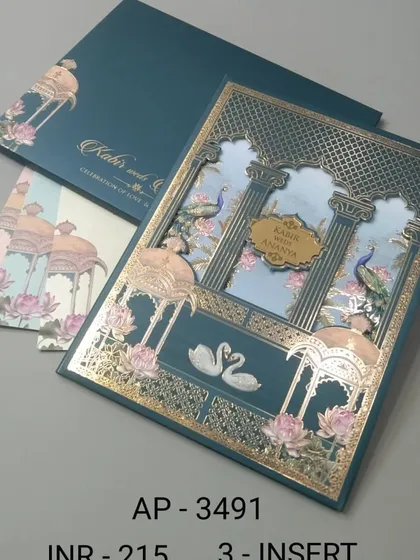 I designed this card with a stunning laser-cut palace gate in rich gold foil against a teal background. The scene is complete with elegant swans and peacocks, creating a fairytale entrance to your wedding details.