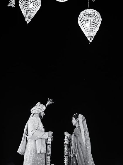 A powerful black and white silhouette of the couple during their wedding ceremony. The dramatic lighting and composition create a timeless and artistic image of their union.