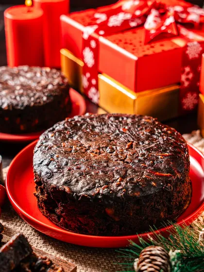 A close-up of our classic Christmas Plum Cake, highlighting its dark, moist texture packed with candied fruits and spices. It's a taste of tradition, lovingly baked for your family.