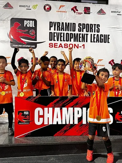 Champions! Our U7 team proudly displays their trophy after winning the Pyramid Sports Development League (PSDL). A fantastic achievement for our little Lions and their coach.