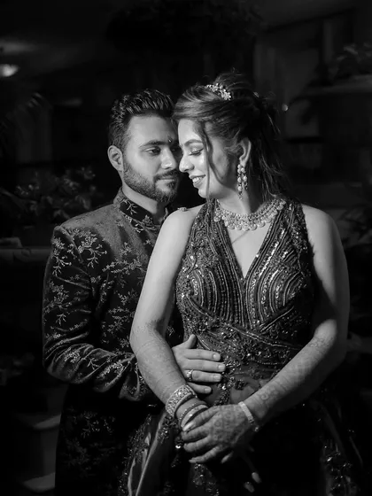 A classic black and white portrait of the couple from their engagement. The timeless feel of monochrome photography emphasizes their emotional connection and elegant attire.
