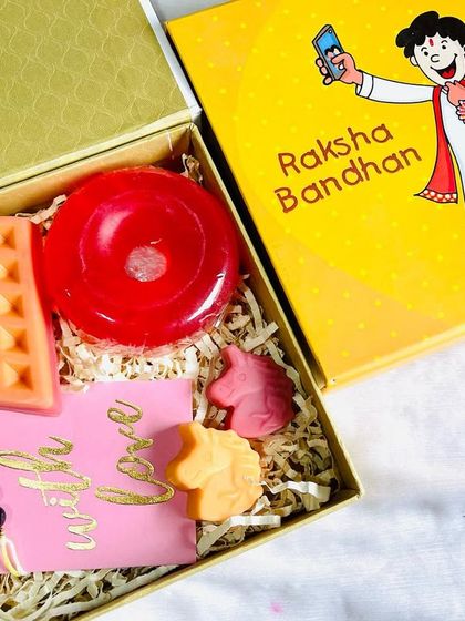 A cute Raksha Bandhan hamper for siblings. It includes a mango waffle soap, strawberry donut soap, mini unicorn soaps, and a special Amethyst Rakhi for focus and concentration.