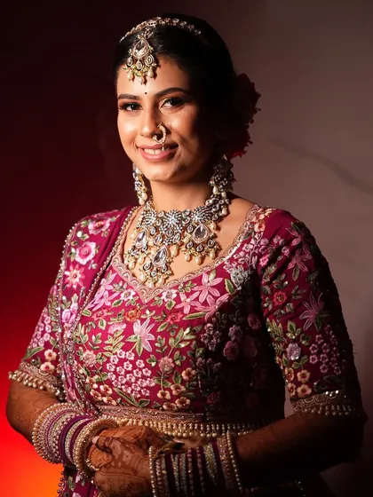A smiling portrait of the bride. The makeup is fresh and radiant, letting her natural beauty shine through.