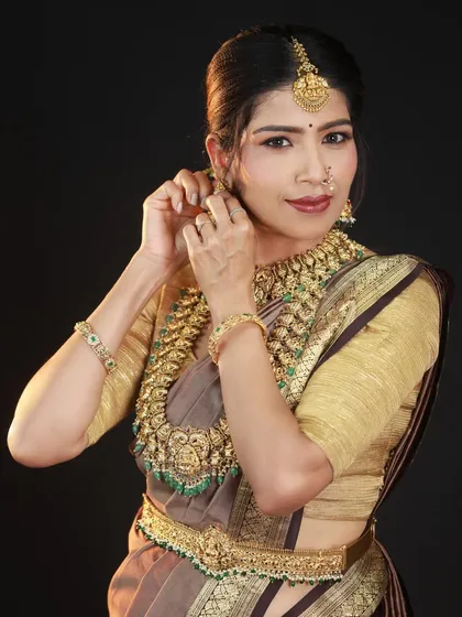 A simple, natural pose of adjusting an earring draws the viewer's attention directly to the jewellery. It’s an effective way to get a detailed shot that doesn't feel staged.