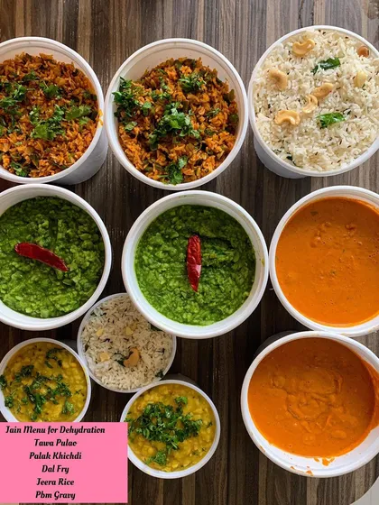 Preparing a Jain menu for dehydration. This order included Tawa Pulao, Palak Khichdi, Dal Fry, and Paneer Butter Masala gravy, all made without onion or garlic and ready to be packed for travel.