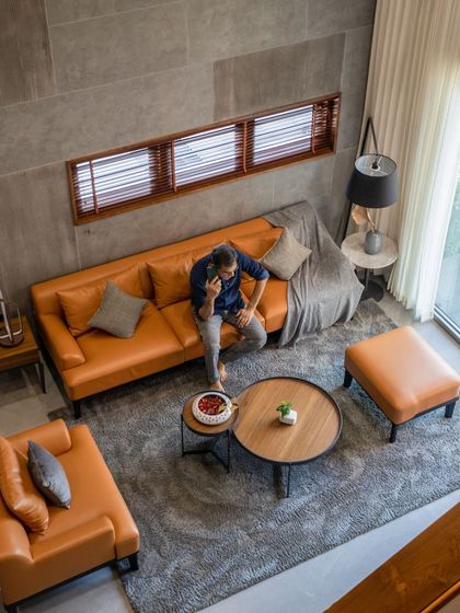An overhead view of the living area highlights the open, airy feel of the space. The layout is designed for relaxation and social gatherings, with carefully selected furniture that defines the zone while maintaining a connection to the rest of the home.