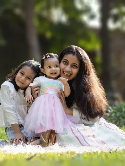 A loving portrait of a mother with her two children. The soft, natural light of the outdoors creates a beautiful, timeless feel.