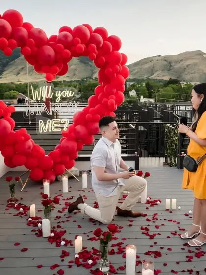 An outdoor proposal in action. The rooftop setting provides a beautiful, private backdrop for this special moment we helped create.