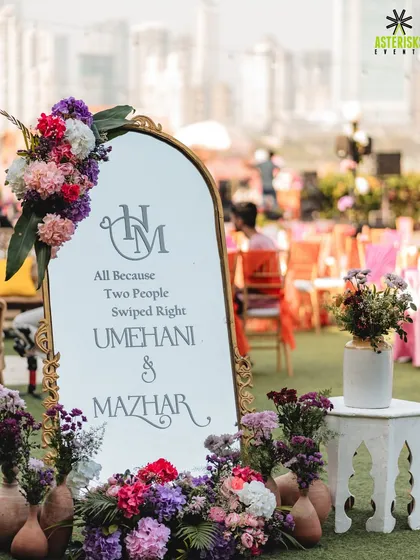 A personalized welcome mirror with a cute quote, "All Because Two People Swiped Right," adds a modern and personal touch to the Mehendi decor.