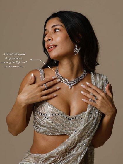 A classic diamond drop necklace catching the light with every movement. It's the perfect elegant touch for a reception or engagement party.