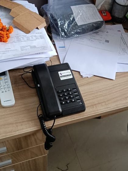 A telephone handset on a busy office desk. Our systems are built to handle the communication demands of a dynamic workplace.