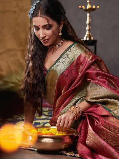 A gentle moment captured in warm light. The makeup is subtle and enhances the model's natural features, creating a look that is both traditional and effortlessly beautiful.