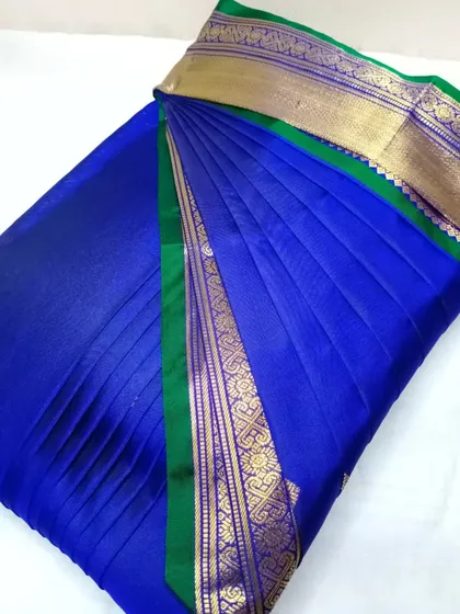 A royal blue and green silk saree, pleated and ready for delivery.