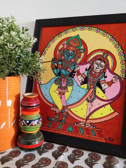 The 'Banke Bihari with Radha Pyari' painting, shown here in a home setting. The playful colors of the art are complemented by the simple decor, showing how a single piece can define the mood of a space.