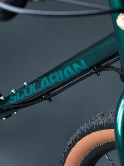 The Scolarian branding on the frame. I partner with expert frame builders to ensure the heart of your custom bike is perfectly tailored to you.