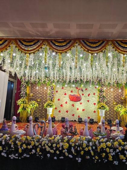 A wide, symmetrical shot of the complete swan-themed stage decor.