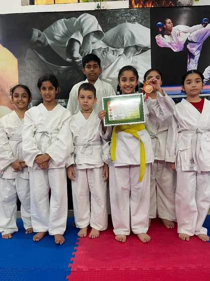 Our students posing with their medals and certificates. We teach them to be proud of their accomplishments and to always aim higher.