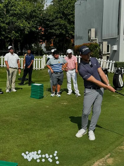 A coach demonstrates a specific chipping motion. The technical precision learned in these seminars is passed down to every athlete in our system.